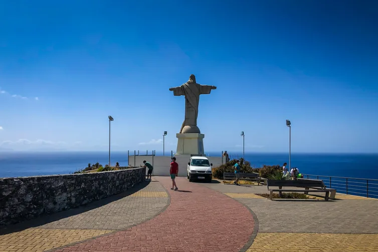 The Cristo Rei statue on the Cabo do Garajau clifftop, arms open over the Atlantic